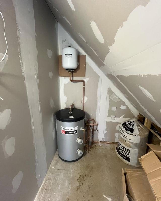 Unvented cylinder with an expansion vessel above, in an unfinished annexe