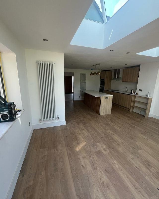 Open-plan kitchen with a tall vertical radiator and a rooflight
