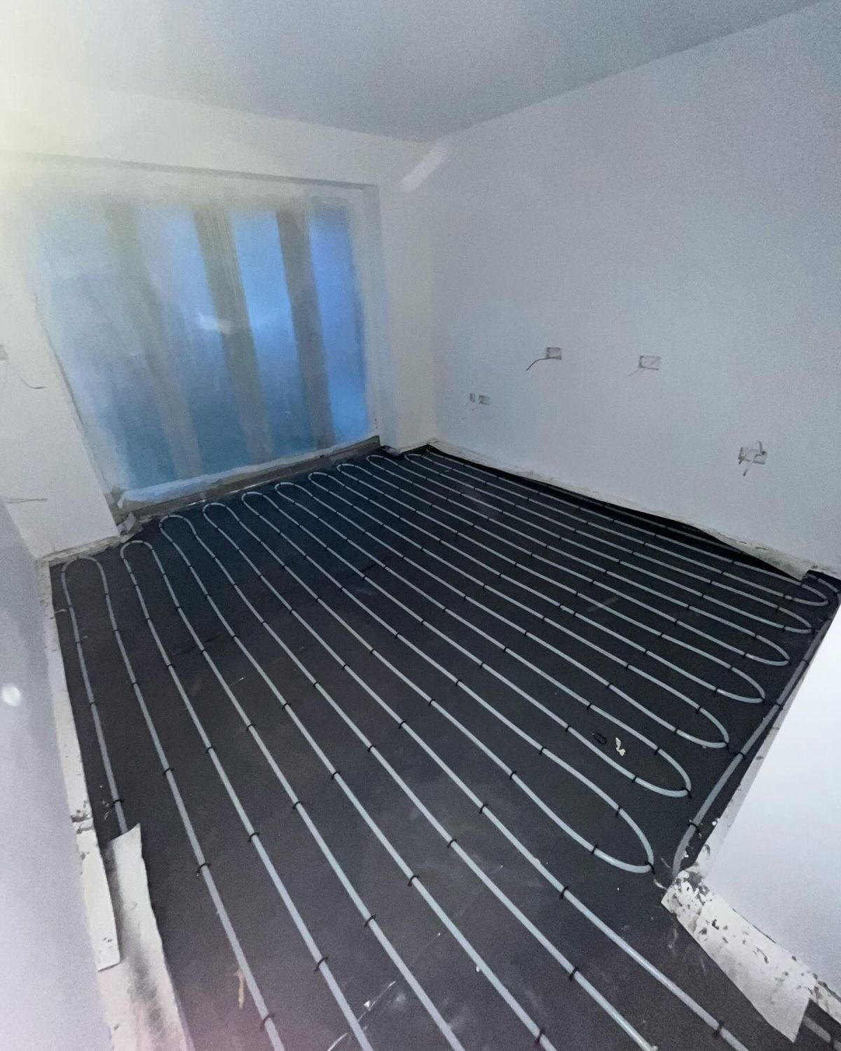 Wet underfloor heating pipework laid out across a large floor