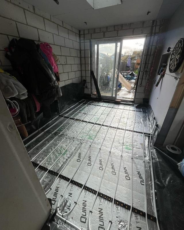 Underfloor heating pipework clipped to insulation boards before screeding